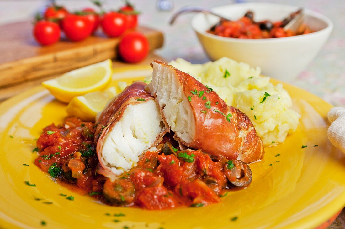 Cod wrapped in prosciutto with tomato sauce