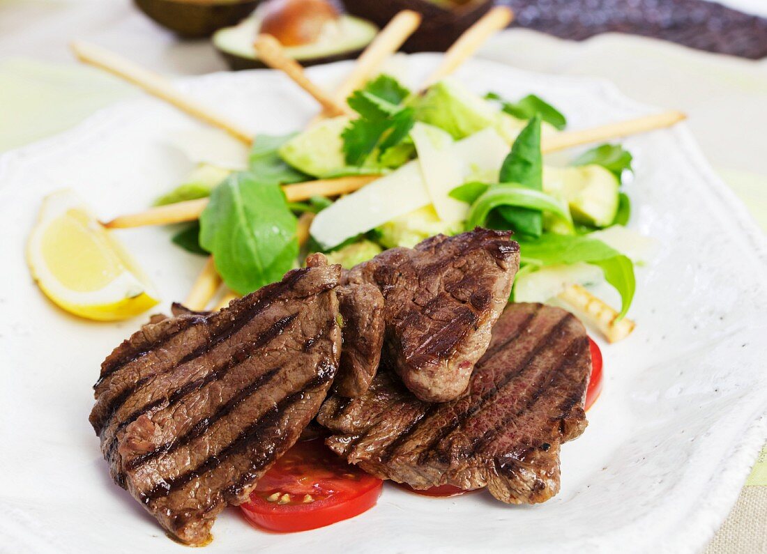 Barbecued beef steaks with avocado salad