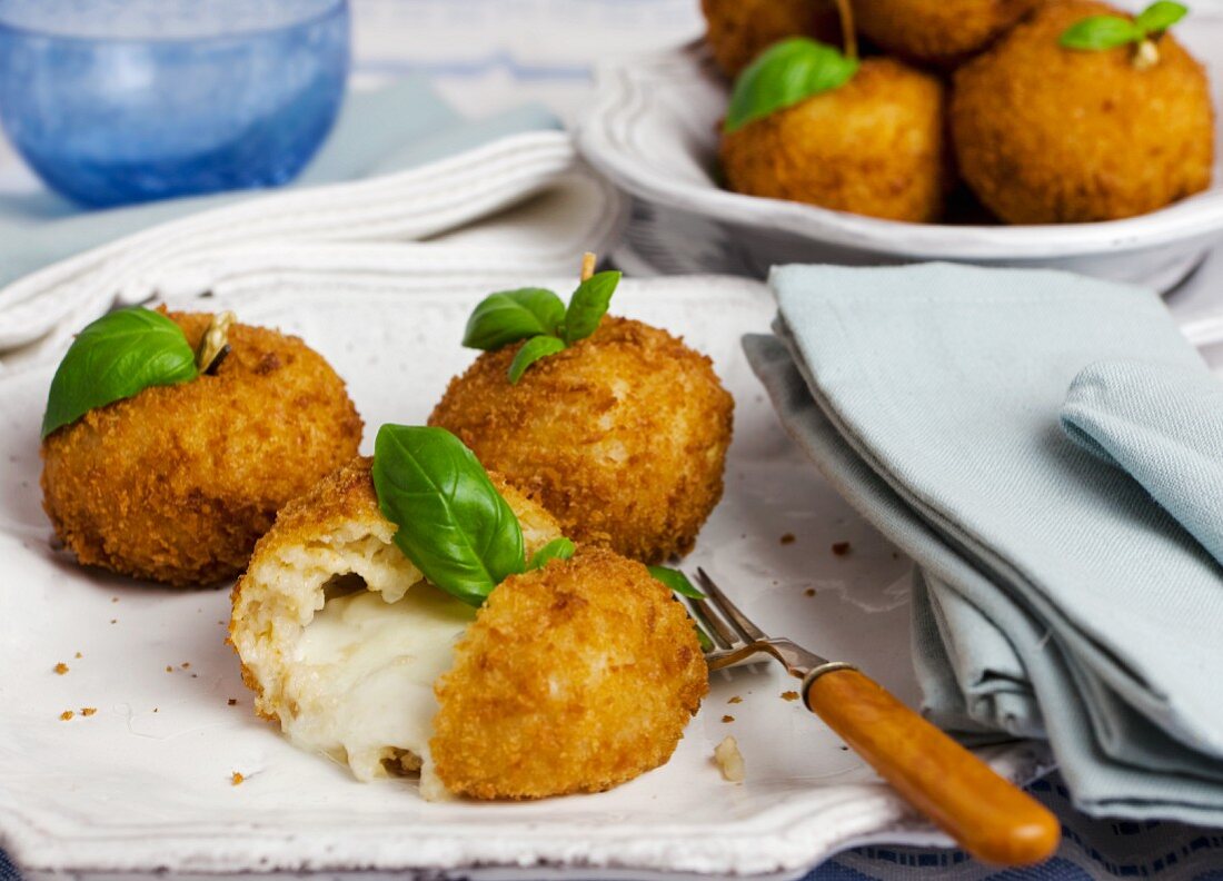 Arancini with cheese filling and basil