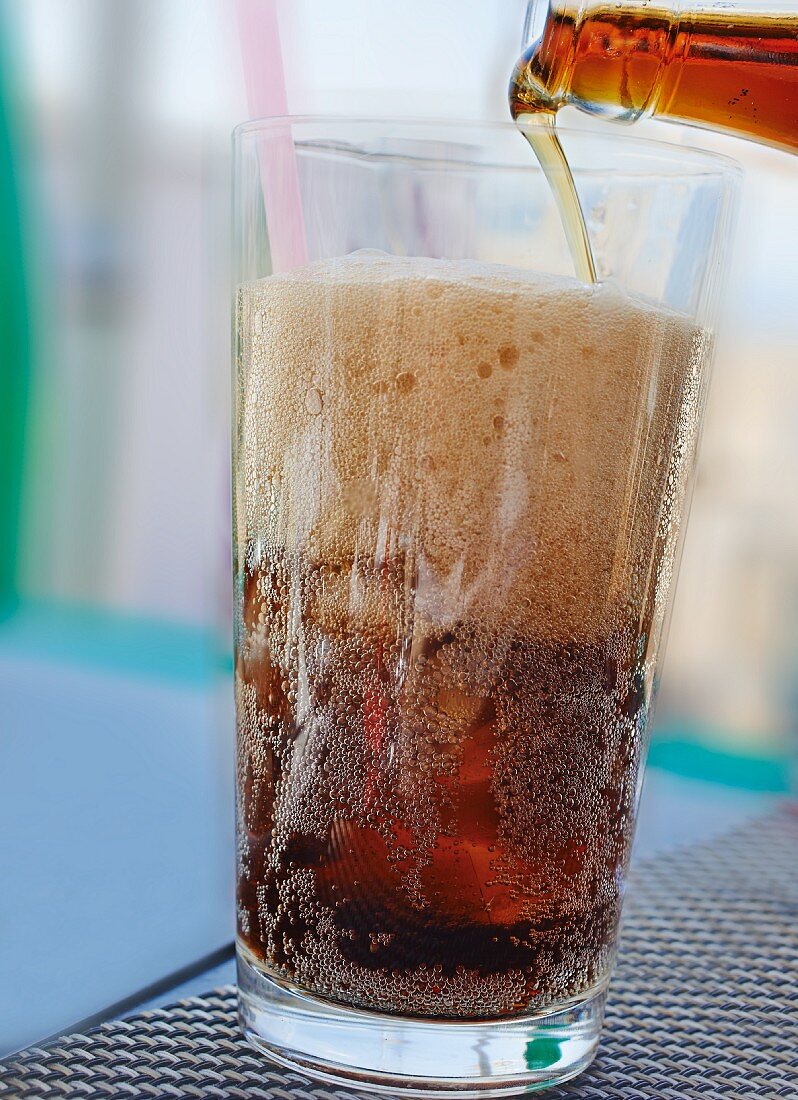 Cola being poured into a glass
