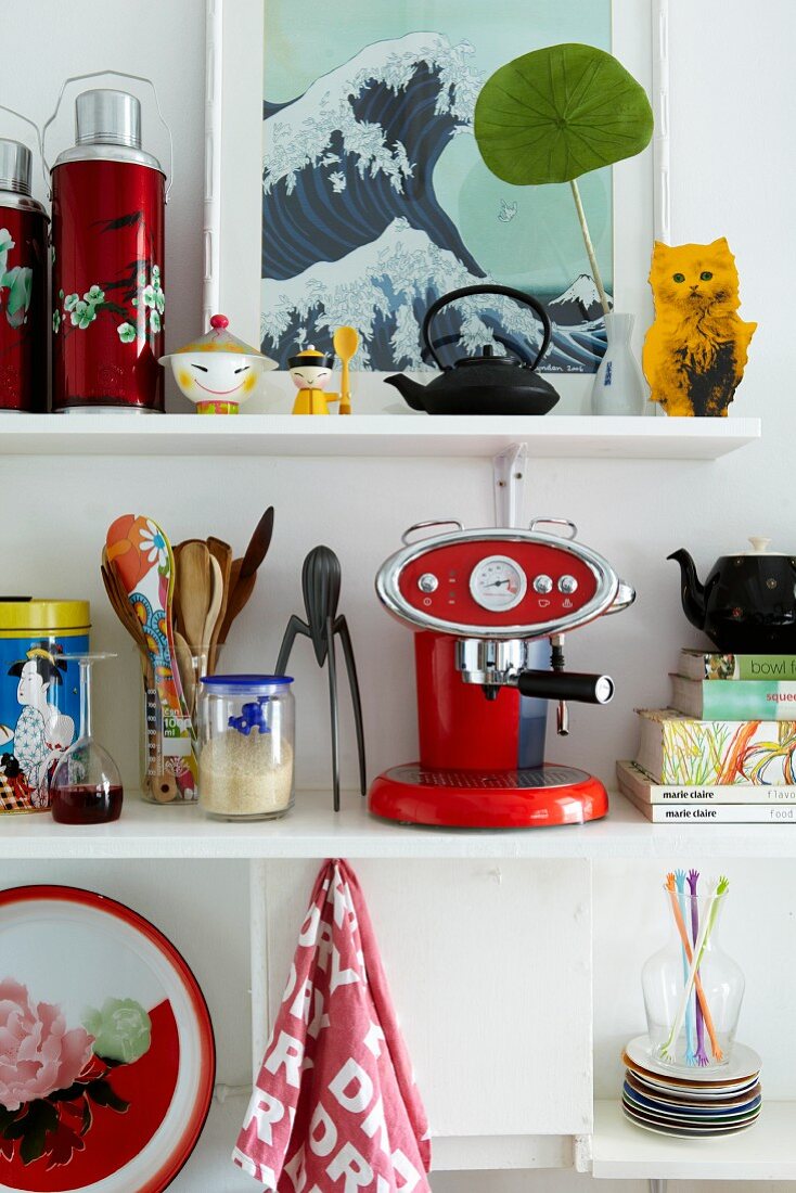 Colourful utensils on white kitchen shelves