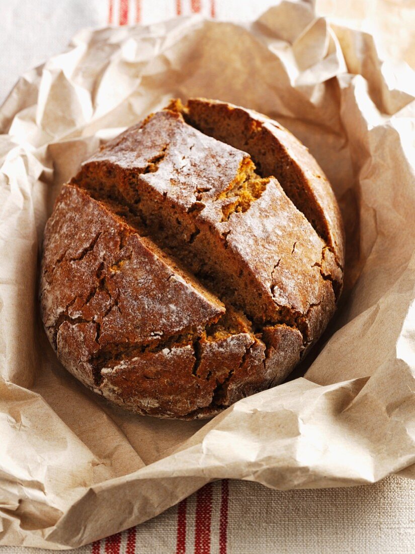 Hearty rye bread on brown paper