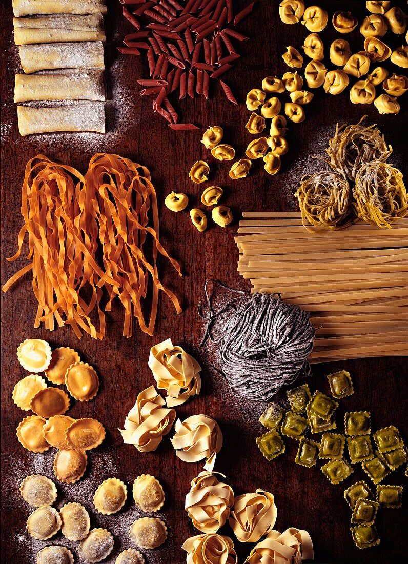 Assorted types of pasta on a wooden board