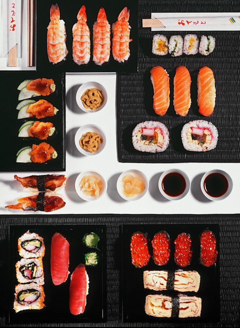 Different types of sushi with ginger, wasabi and soy sauce (view from above)
