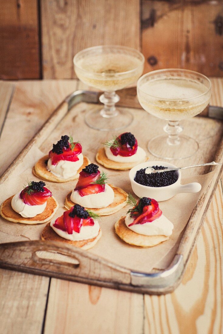 Blinis topped with beetroot, graved lax, crème fraîche and caviar