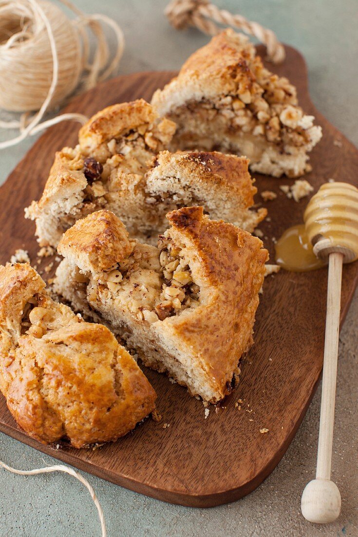 Hazelnut Roll Sliced on a Board with a Honey Dipper