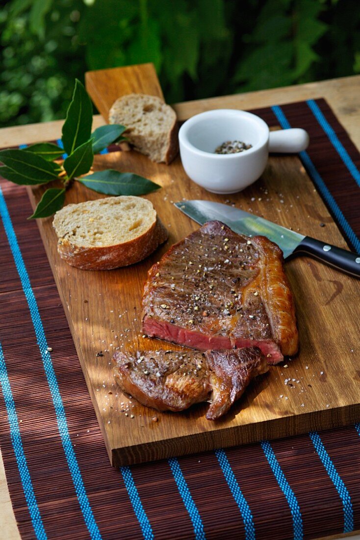 Ribeye steak with salt, pepper and bread