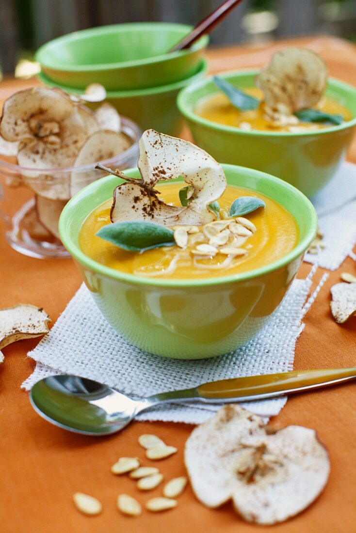 Cream of squash soup with apple crisps and pumpkin seeds