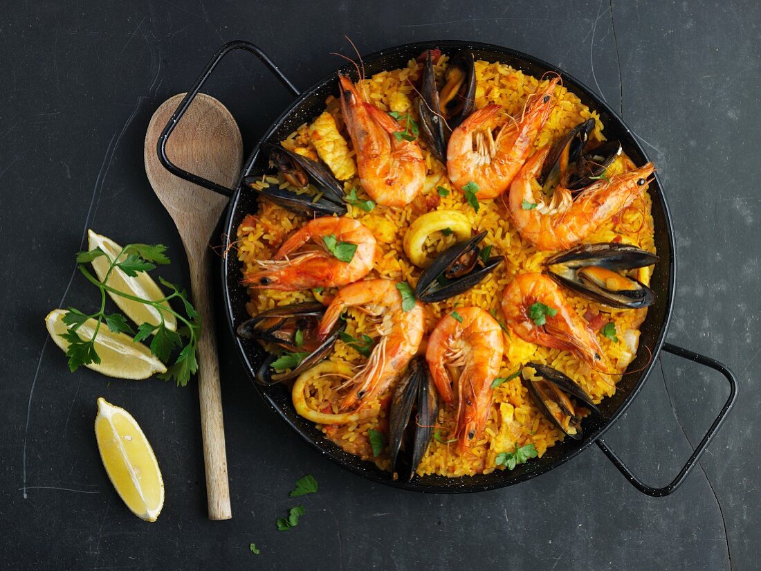 Paella decorated with mussels and prawns