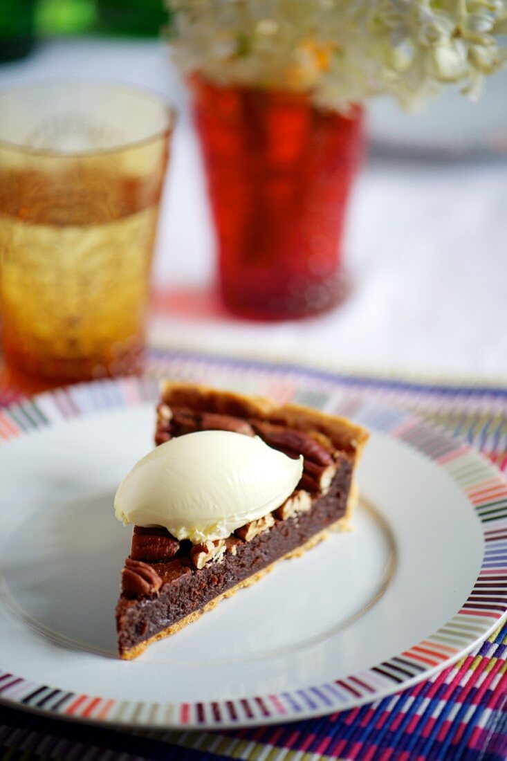 A slice of chocolate and pecan nut tart