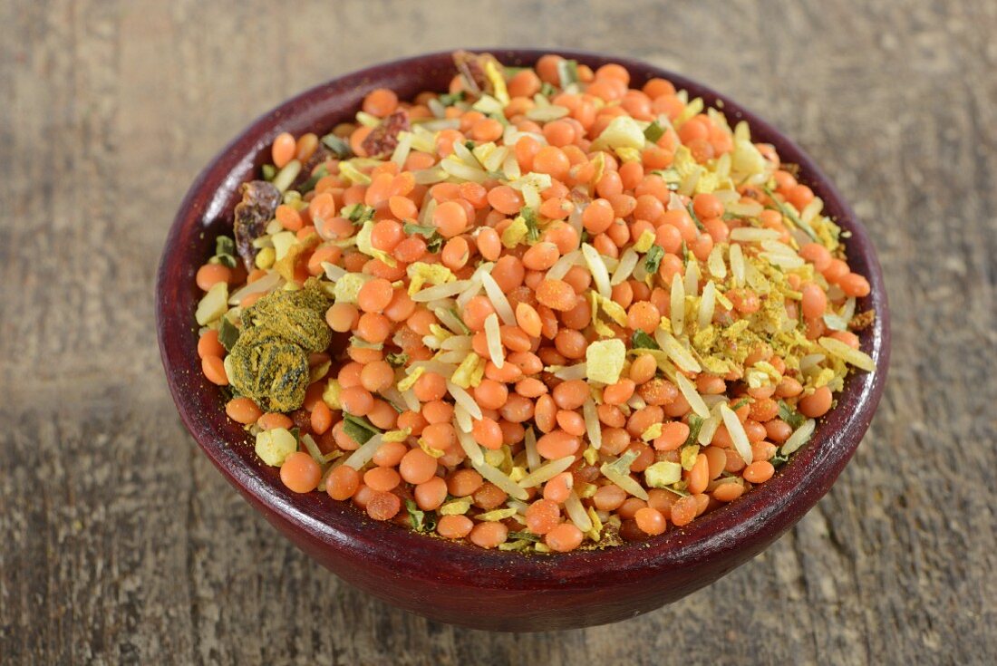 A mix of lentils and rice with herbs and spices in a bowl