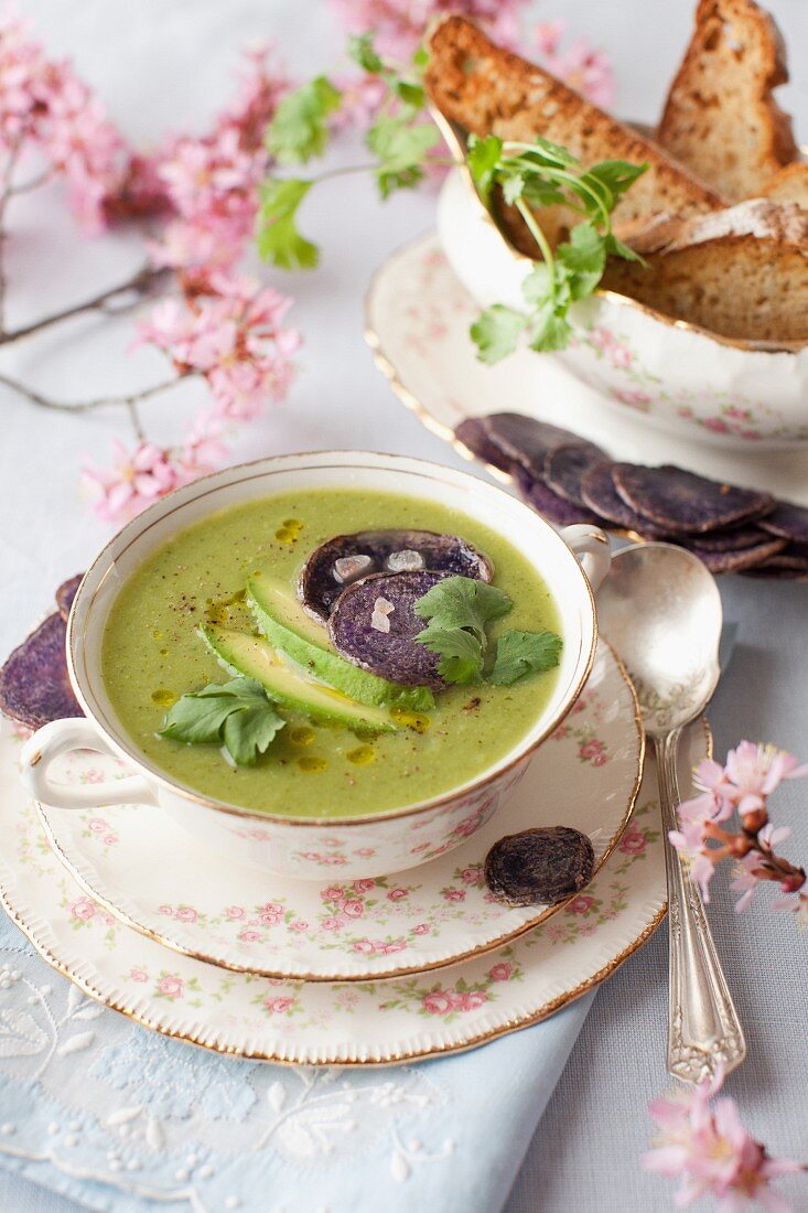 A Bowl of Spring Green Soup with Avocado and Beet Chips