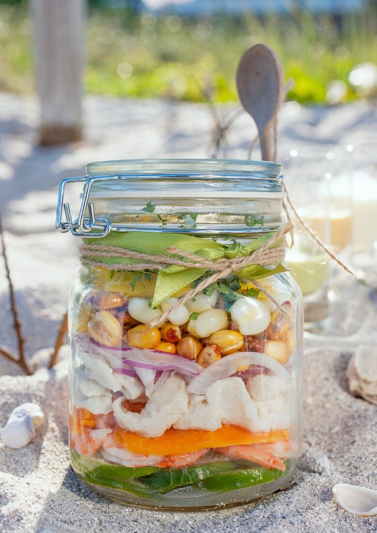 Ingredients for making ceviche, layered in a jar