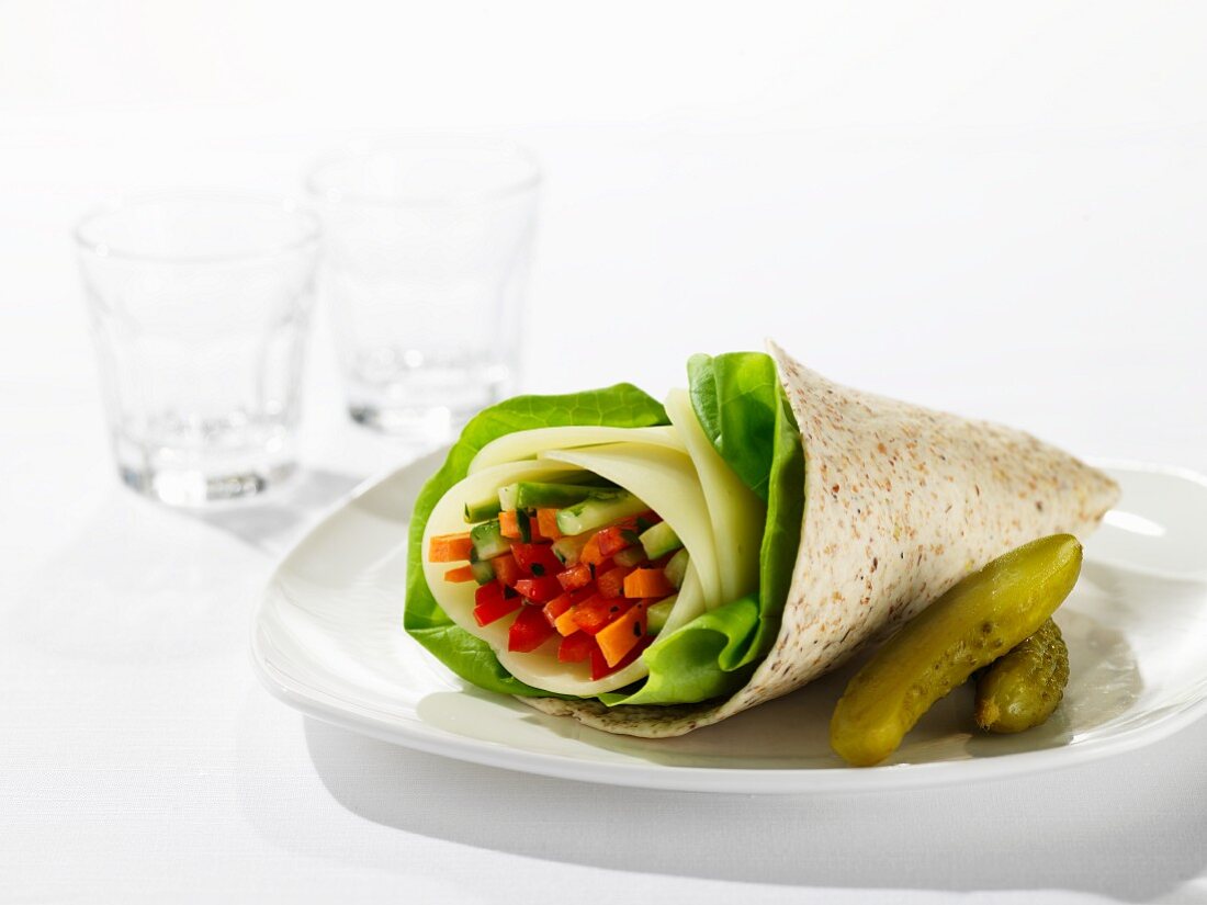 A wrap filled with vegetable batons and salad