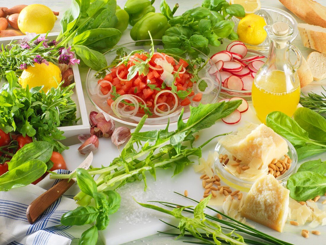 Assorted vegetables, herbs, parmesan, pine nuts and lemons