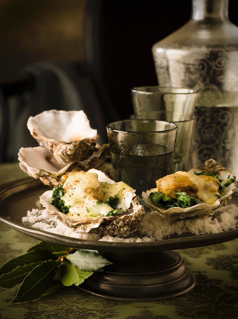 Oysters Rockefeller (oysters with spinach, topped with sauce and baked)
