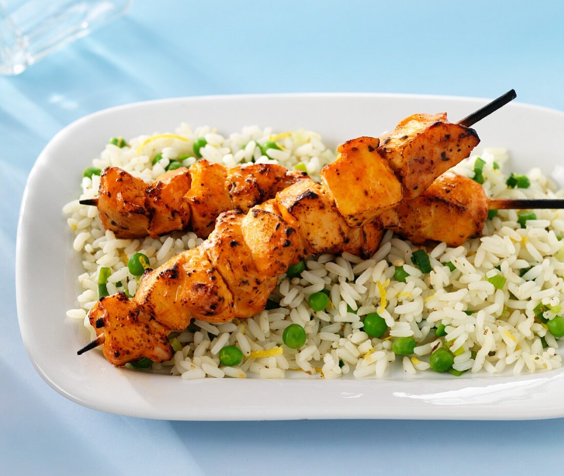 Chicken skewers on a bed of rice