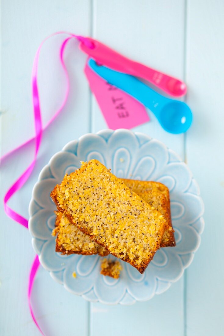 Two slices of gluten-free lemon cake with poppy seeds