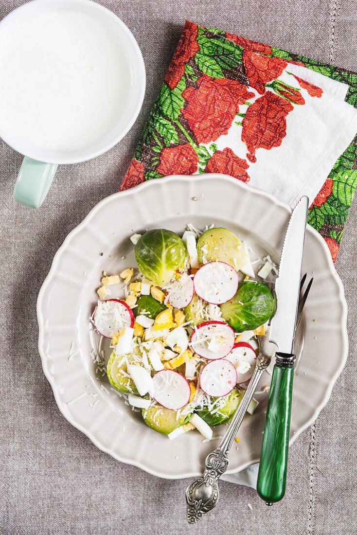 Sprouts with radishes, boiled egg and parmesan, served with yoghurt