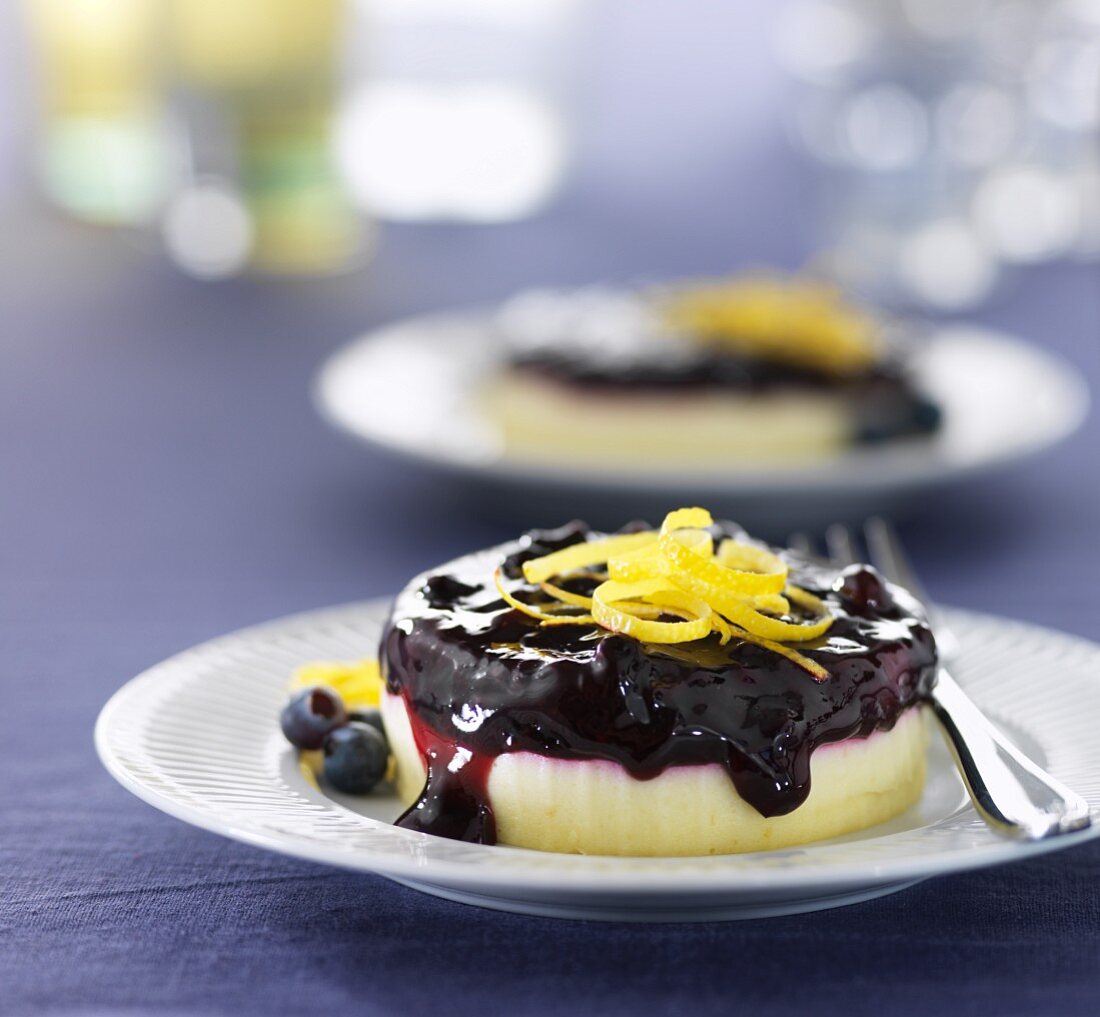 A mini cheesecake with blueberry sauce