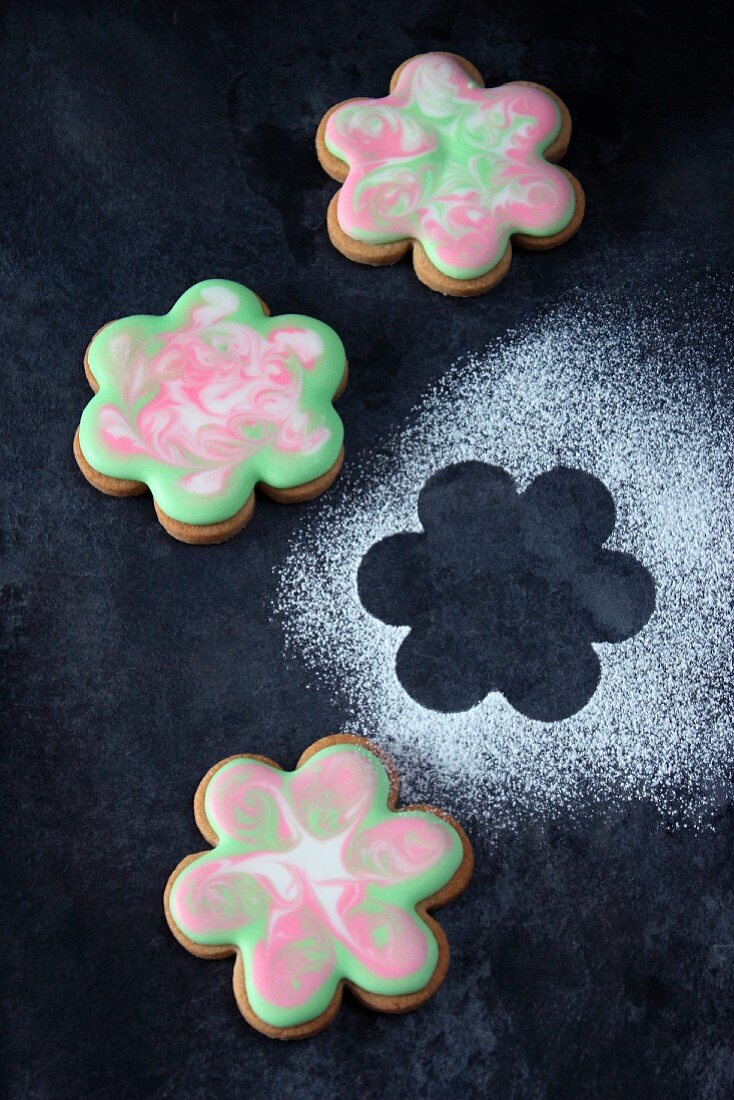 Flower-shaped biscuits decorated with fondant icing