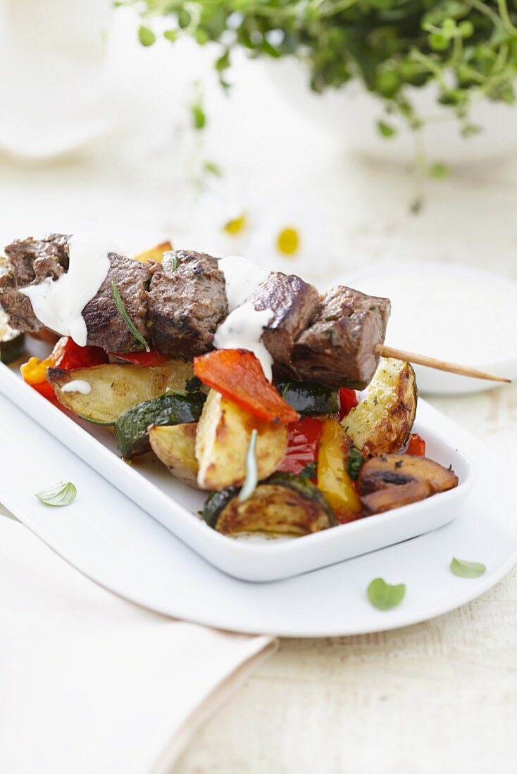 A lamb kebab with roasted vegetables