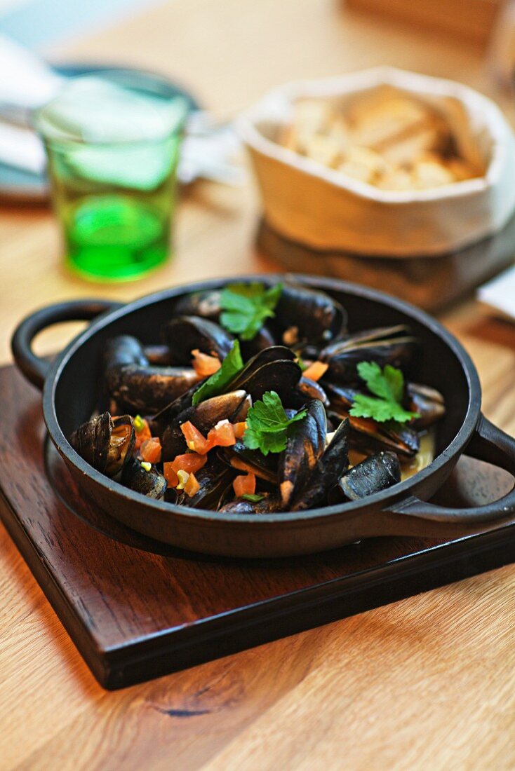 Grilled mussels in a cast iron pan