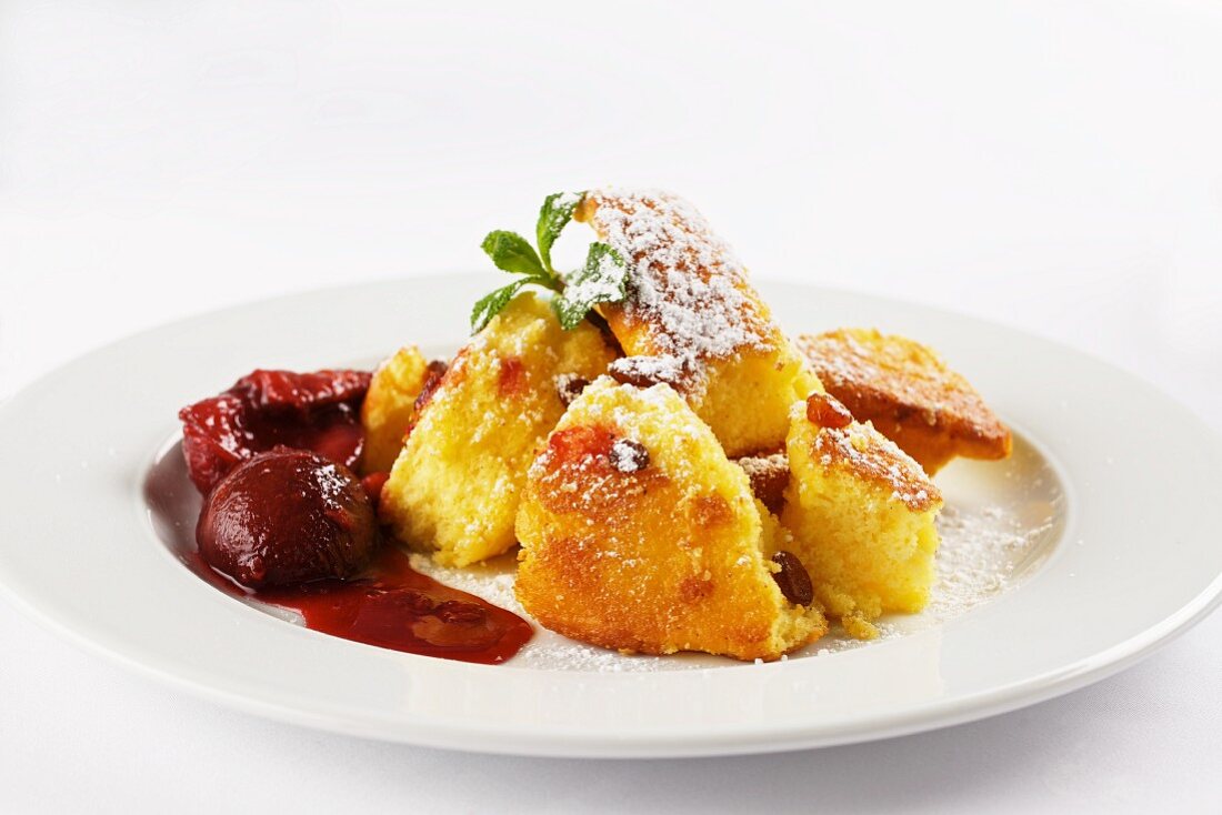 Kaiserschmarren with stewed plums (shredded sugared pancake, Austria)