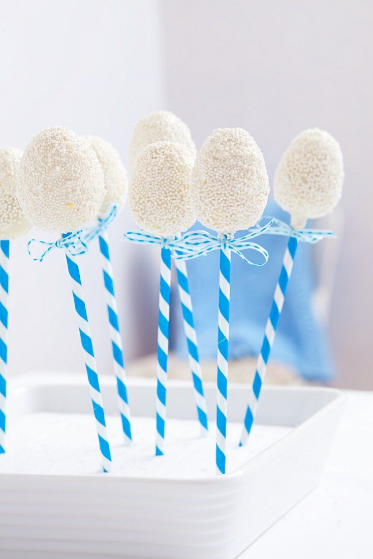 Egg-shaped cake pops coated in white chocolate