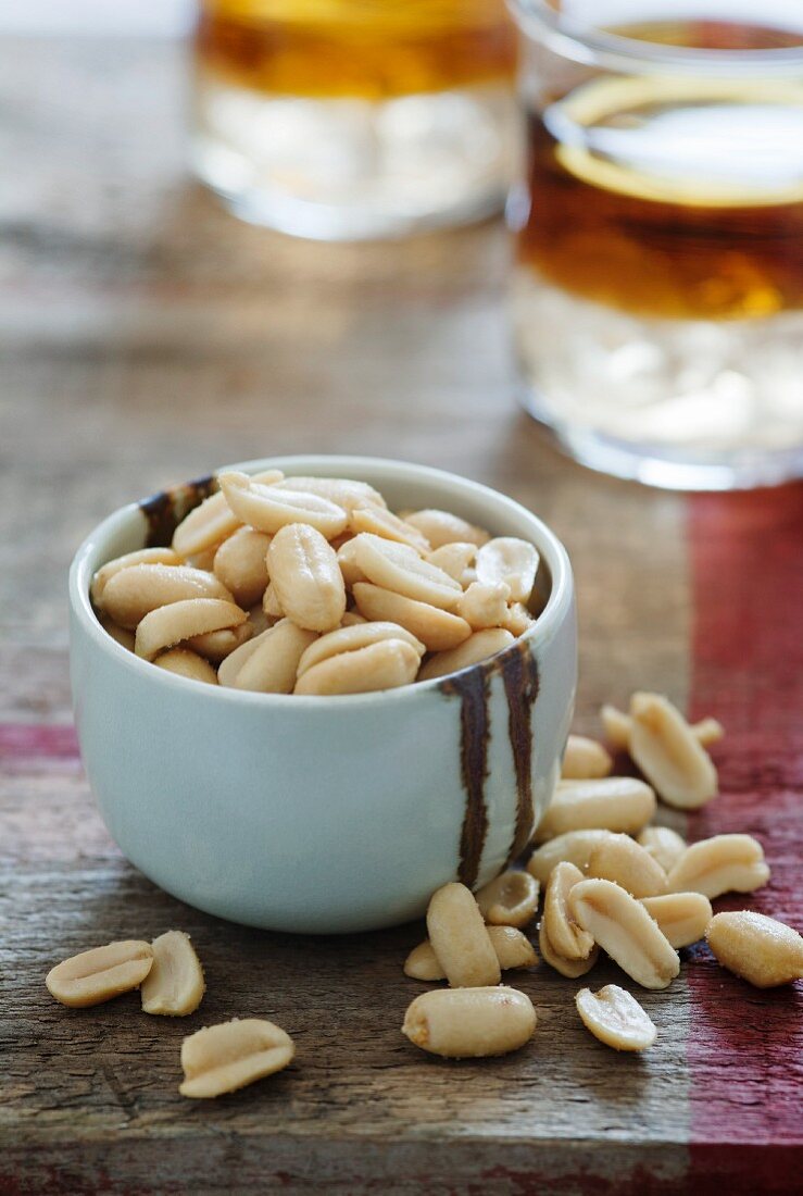 Salted peanuts in a small bowl