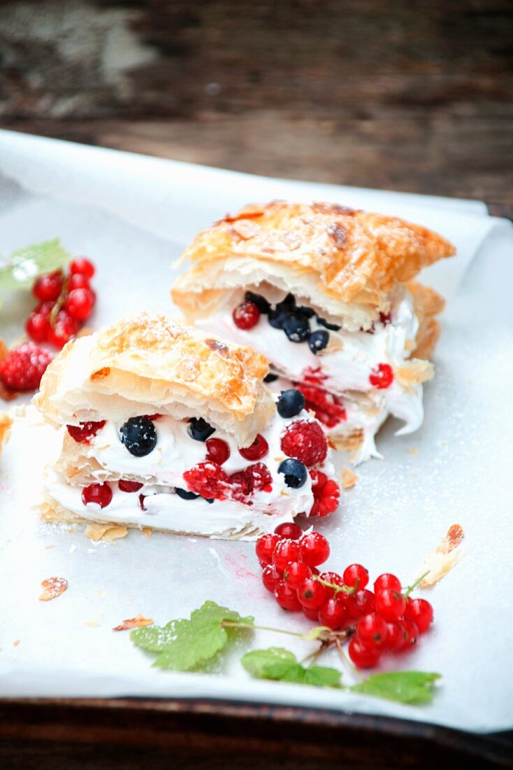 Puff pastry slices with meringue and berries