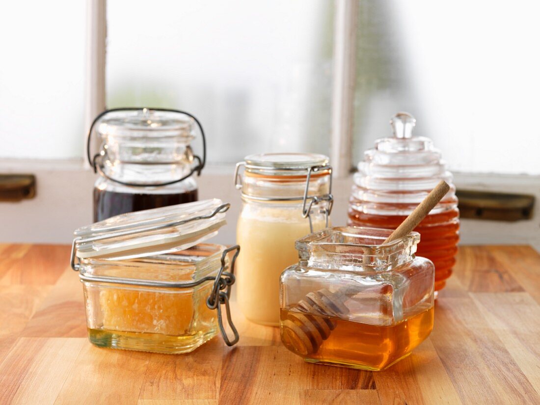 Assorted types of honey in glass containers
