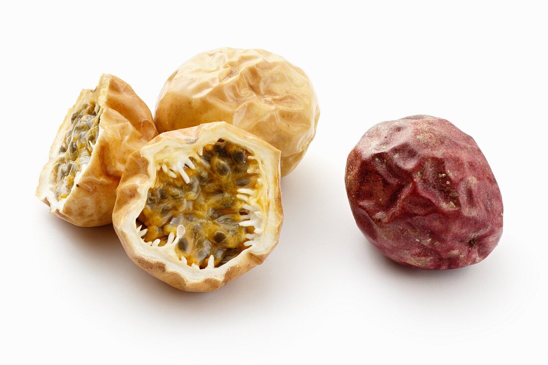 Red and yellow passion fruit, whole and halved