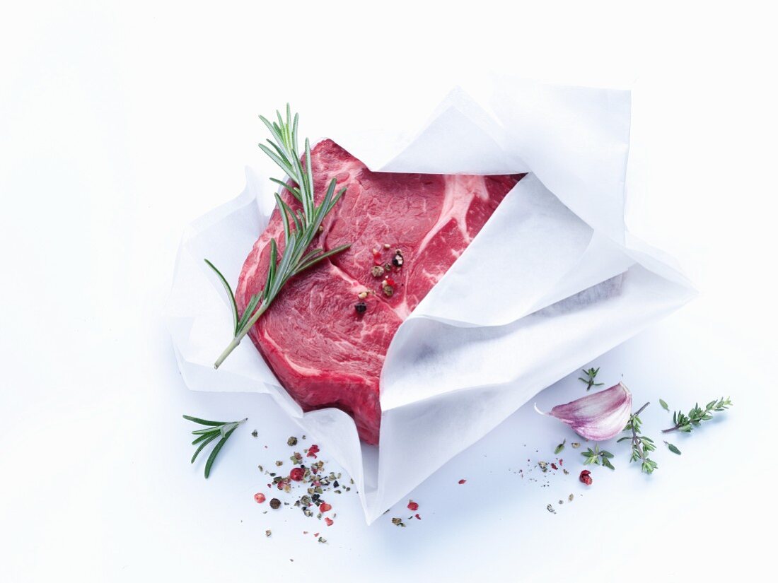 Fresh beef wrapped in paper with herbs and spices