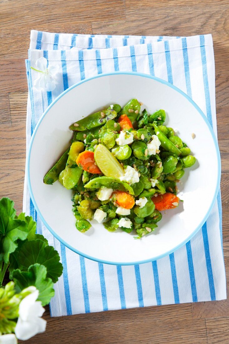 Bean salad with broad beans, peas, carrots, feta and limes