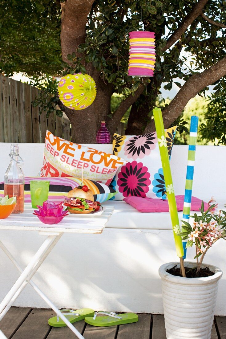 Decorations for a summer garden party (lanterns, pillows and torches)
