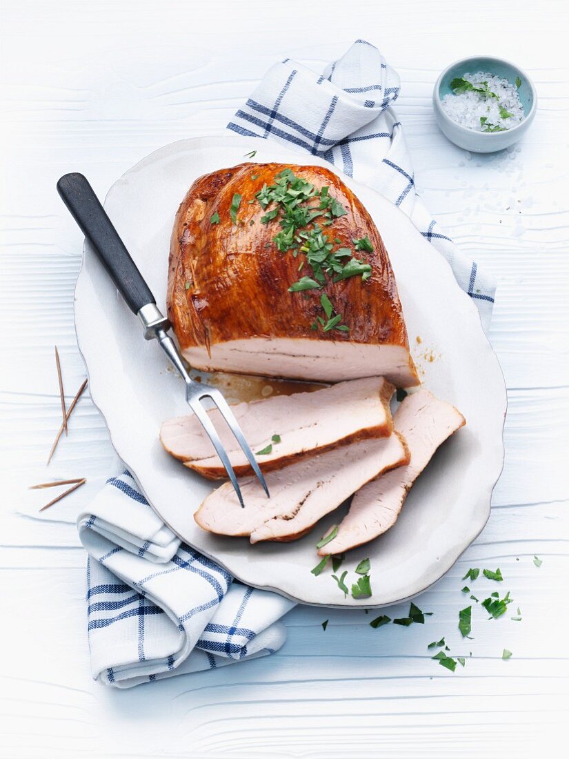 Partially Sliced Roasted Turkey Breast on Platter