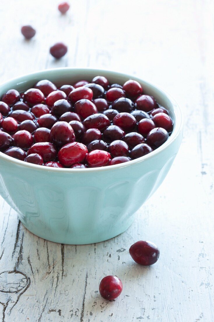Fresh Cranberries Soaking in Water in a Blue Bowl
