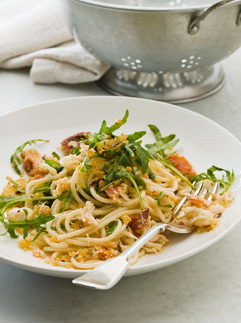 Spaghetti with crab, rocket, pancetta and breadcrumbs