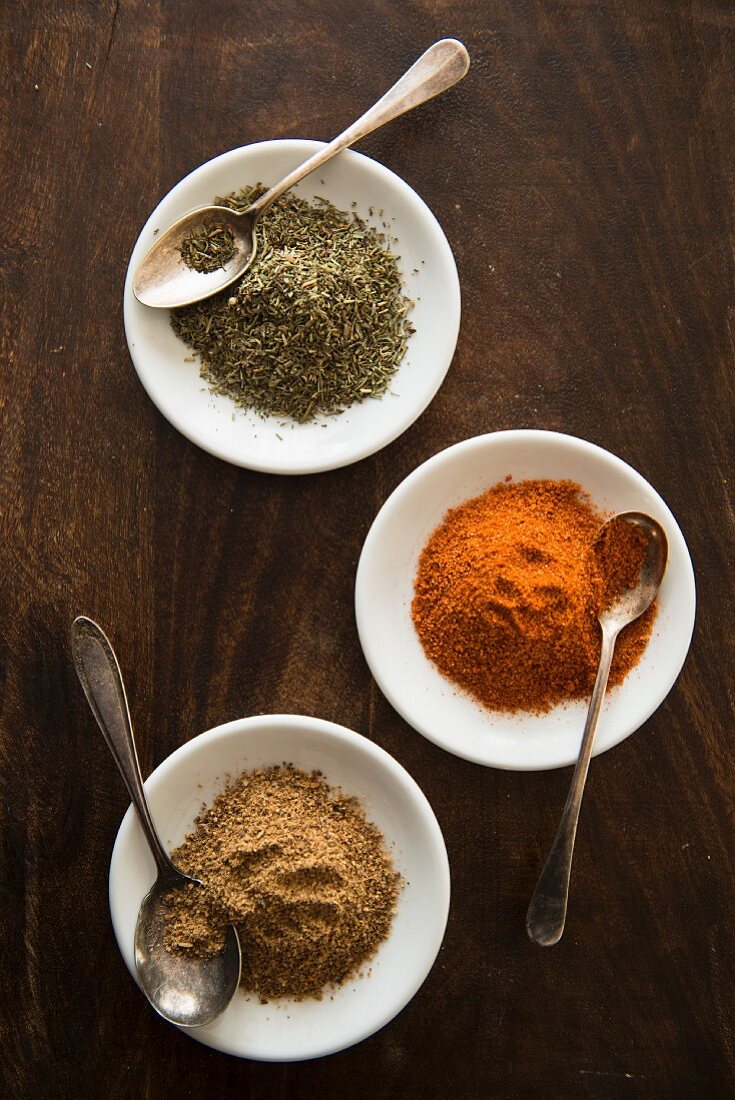 Three different spices in white dishes