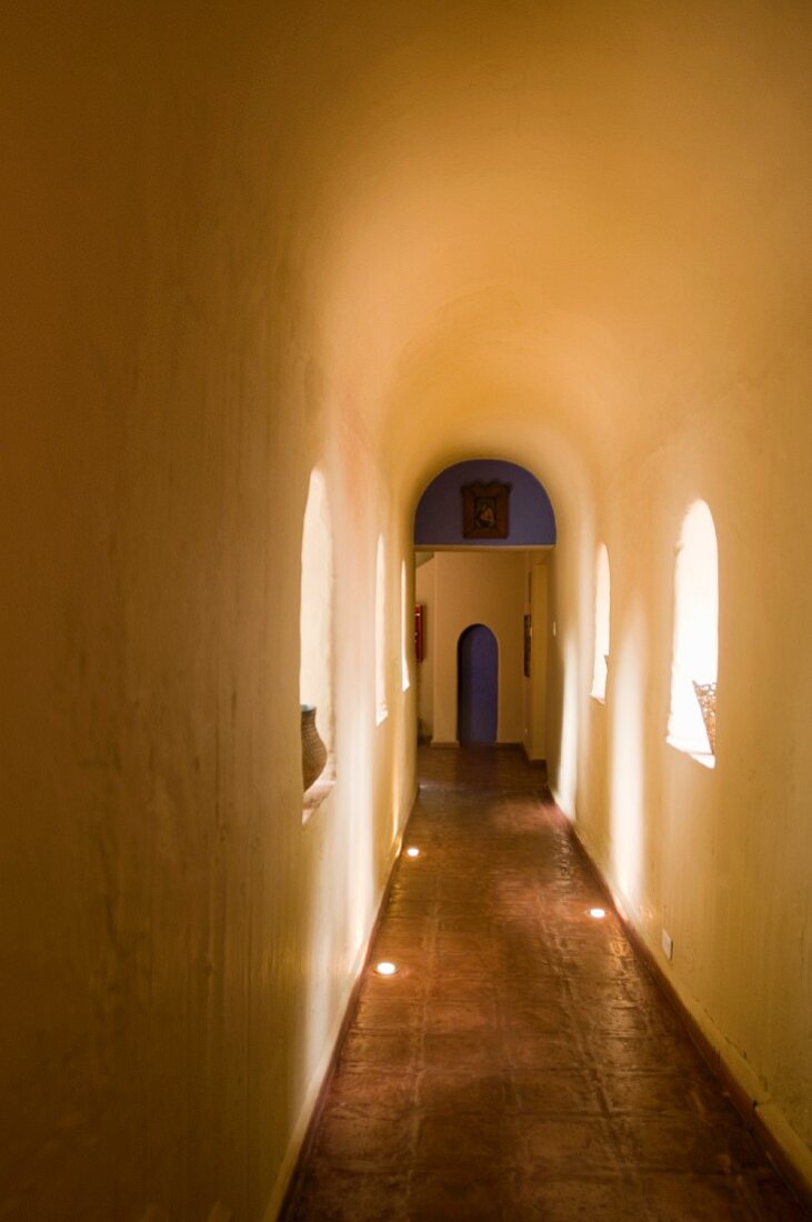 Long, narrow hallway with a barrel ceiling in an Ecuadorian manor house