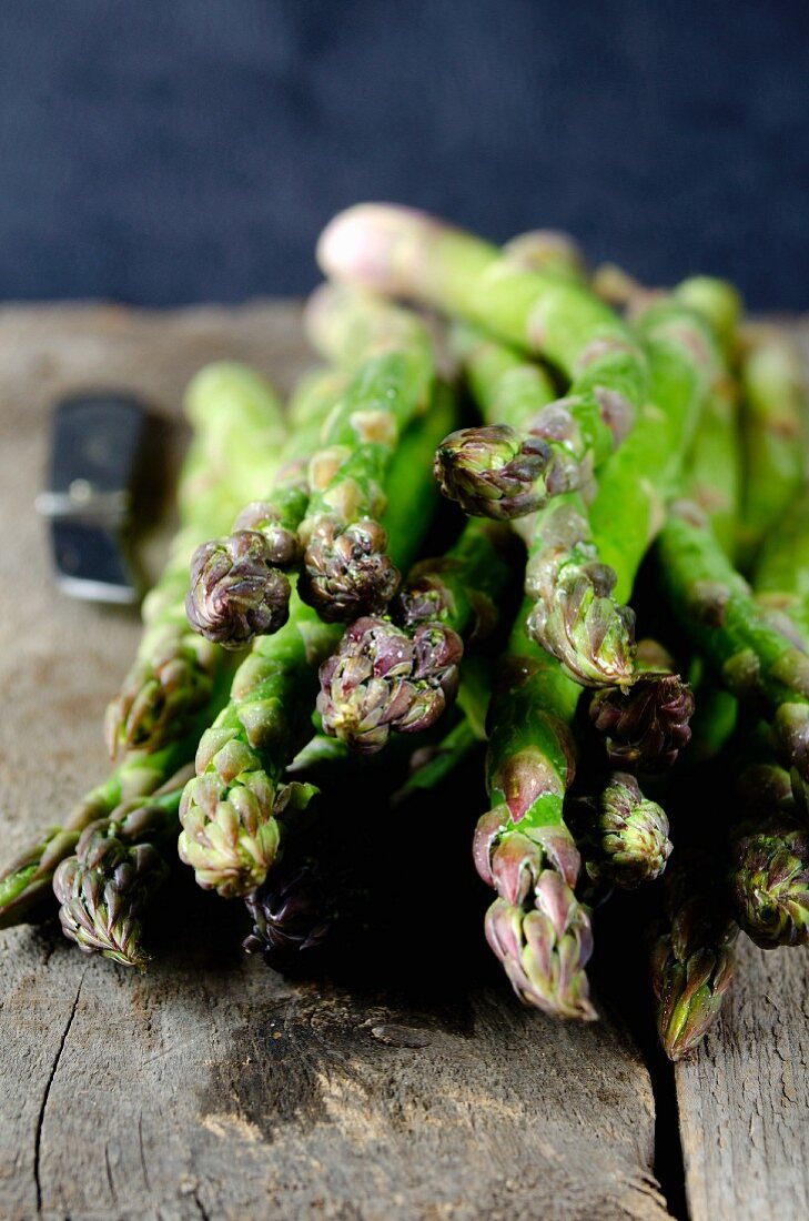 Green asparagus on wooden background