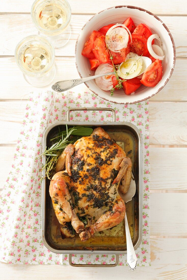 Pollo alla erbe (chicken roasted with herbs) with a tomato and onion salad