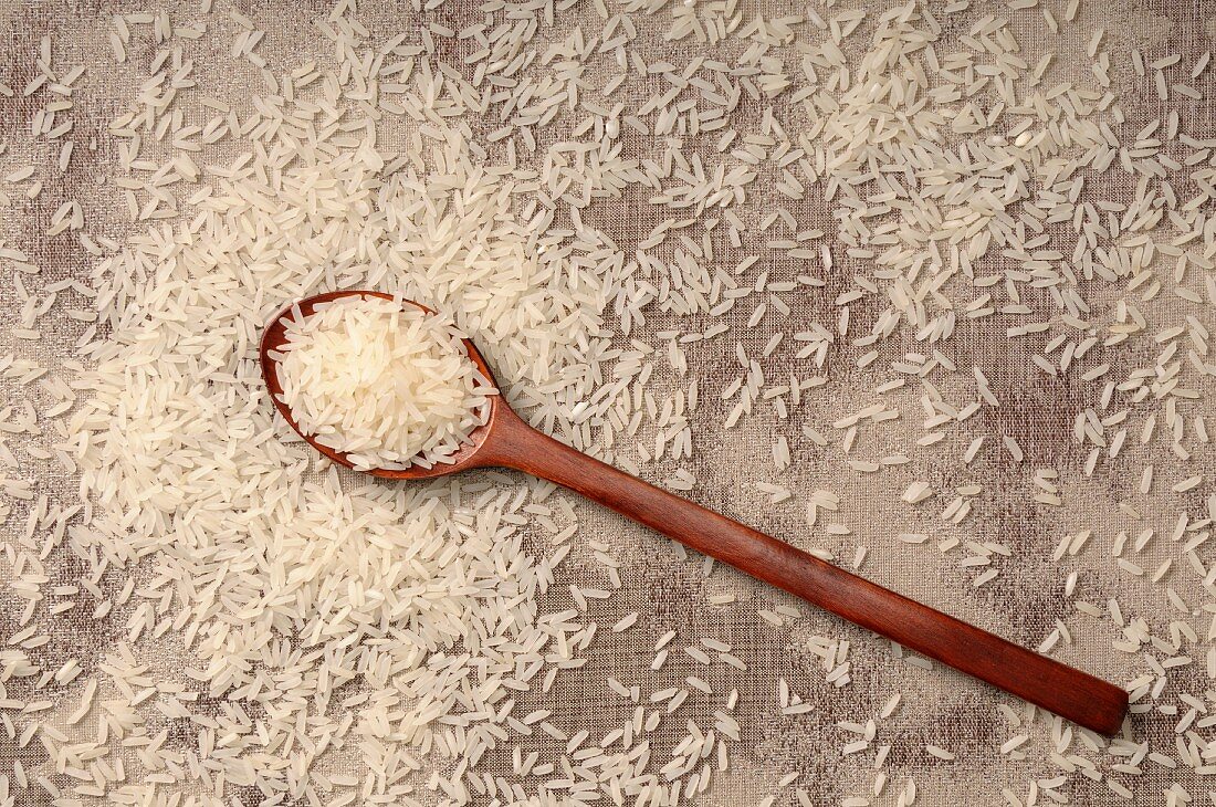 Long grain rice with a wooden spoon