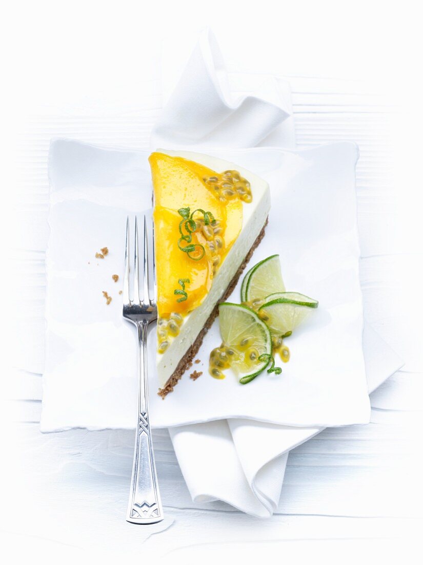 A slice of cheesecake with limes