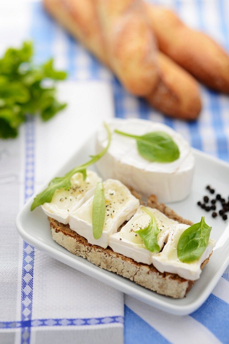 A slice of bread topped with soft cheese