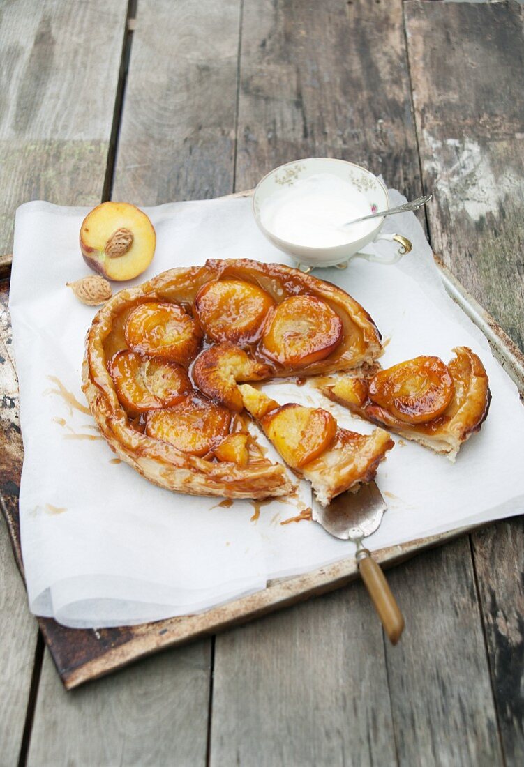 Peach tarte tatin, partly sliced