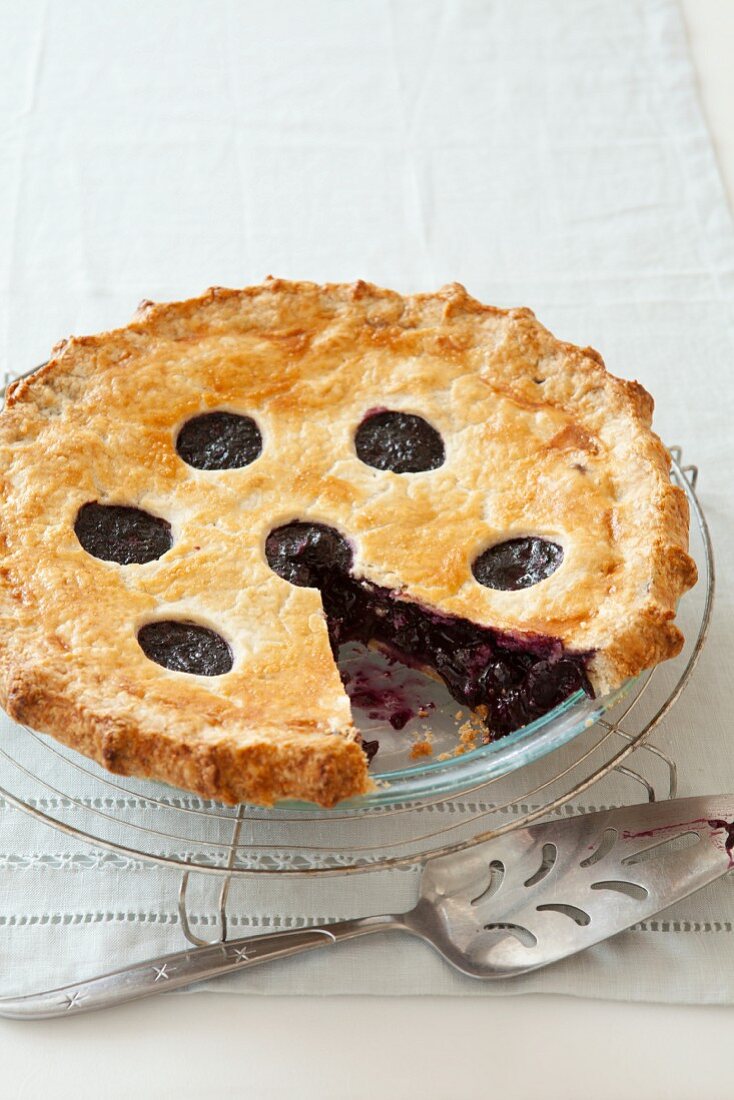 Blueberry pie with one slice removed