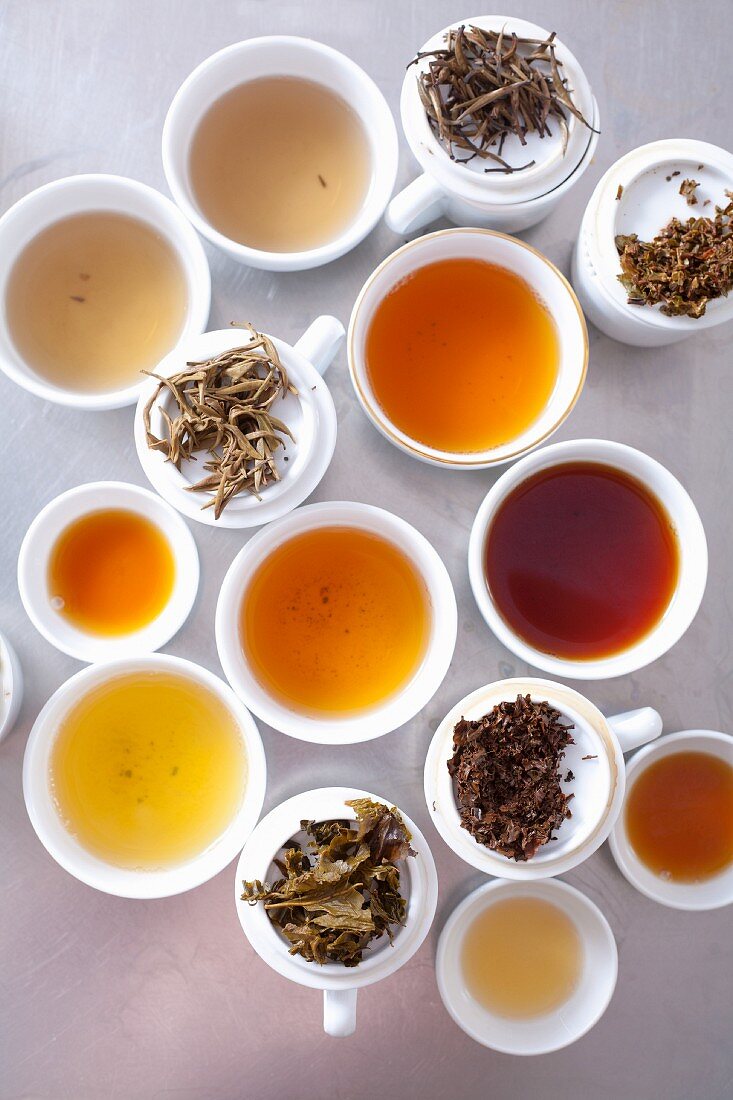 An assortment of brewed teas and tea leaves