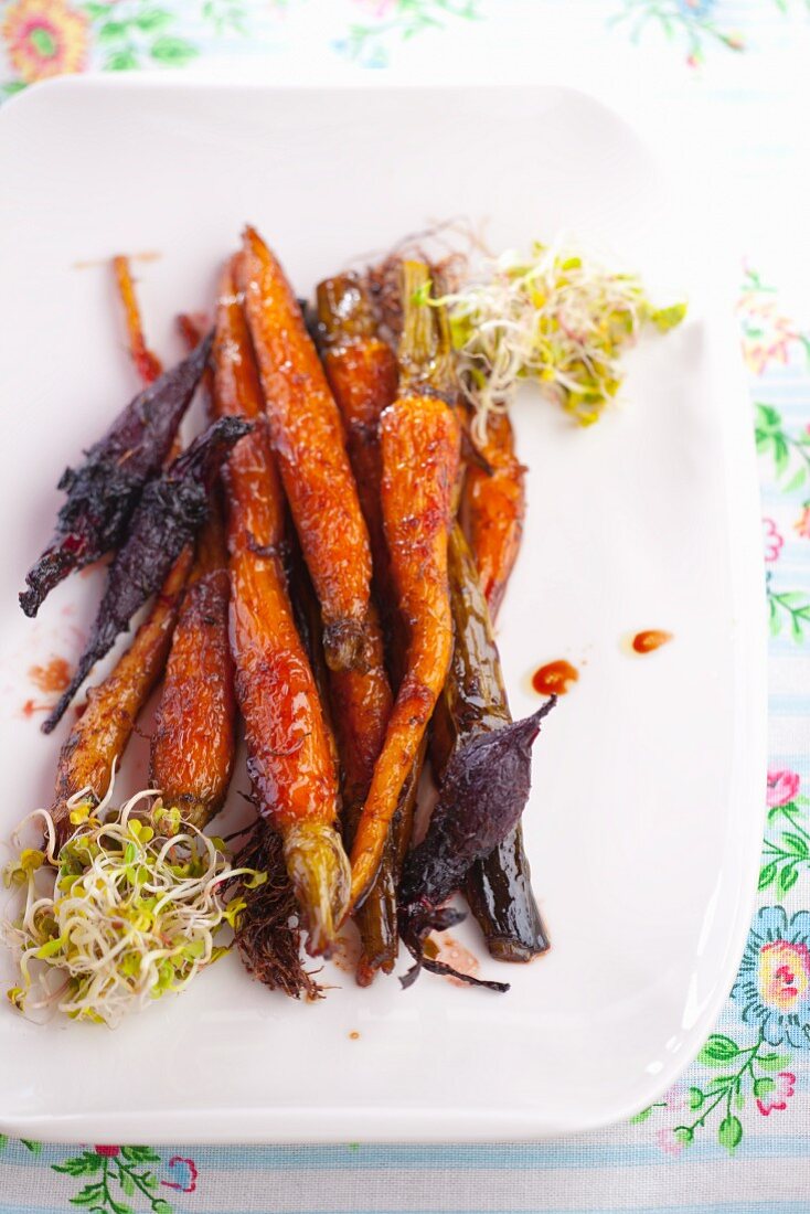Barbecued carrots and beetroot, garnished with sprouts